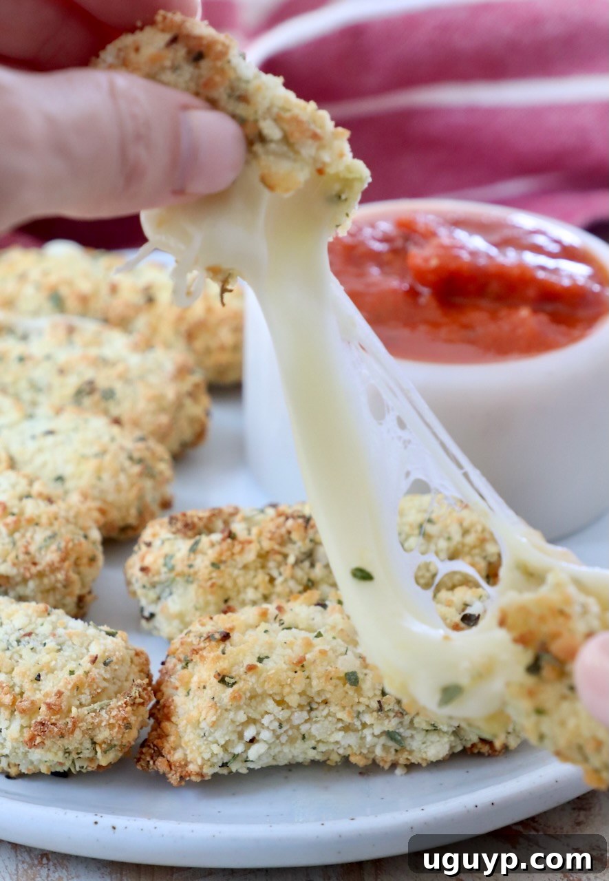 mozzarella stick pulled apart with hands