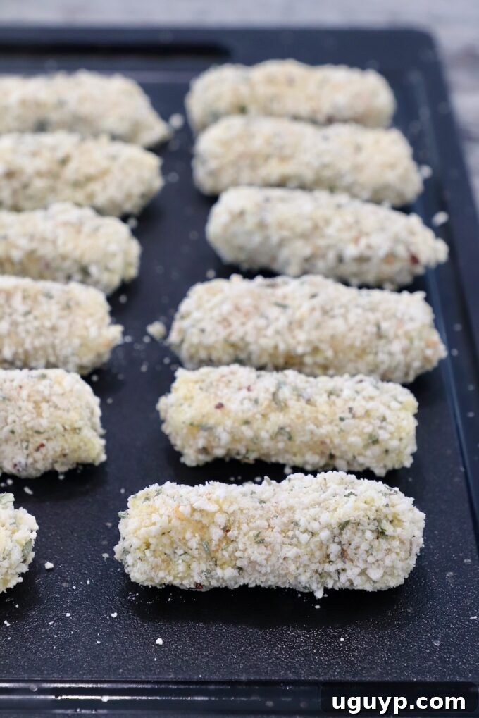 breaded mozzarella sticks on cutting board