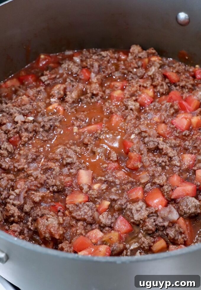 cooked ground beef tomato sauce in large skillet