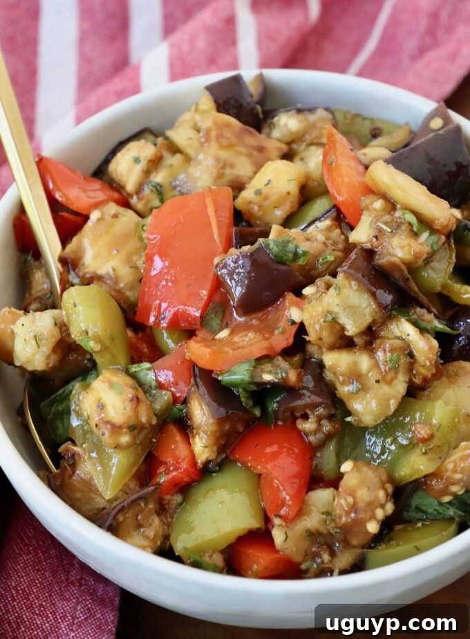 marinated eggplant salad in bowl with spoon