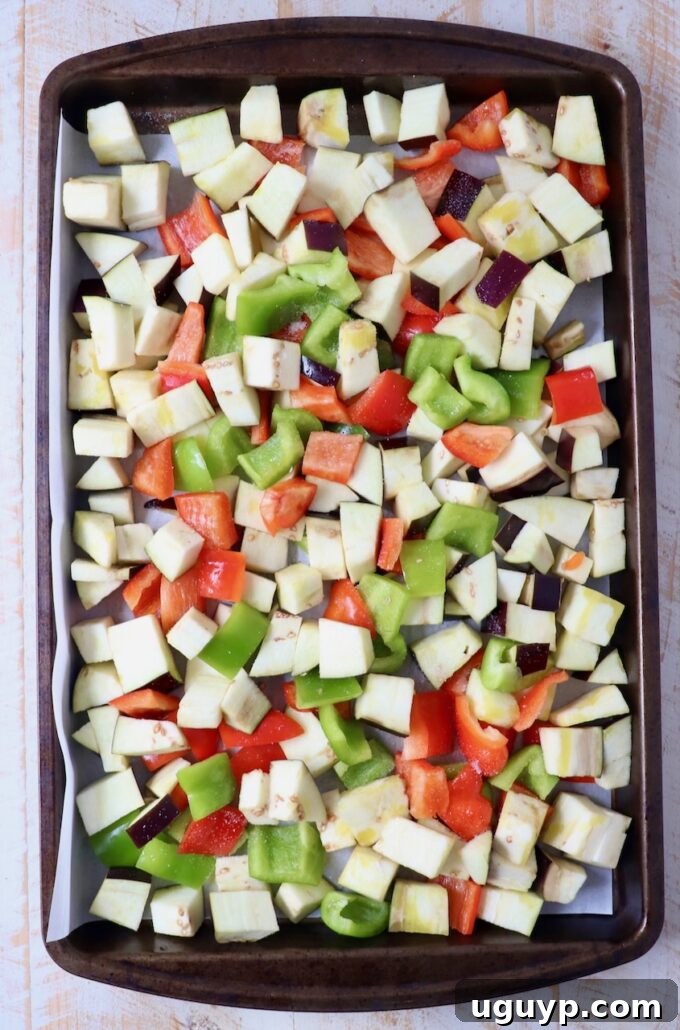 diced eggplant and bell peppers on baking sheet