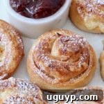 monte cristo rolls on a plate topped with powdered sugar