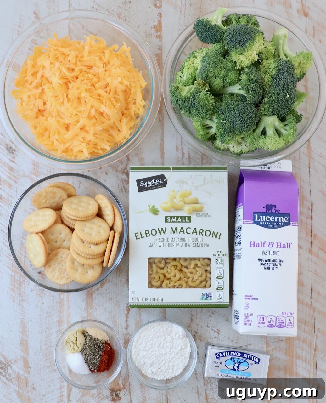 ingredients for broccoli mac and cheese on white wood board