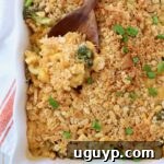 broccoli mac and cheese in casserole dish with serving spoon