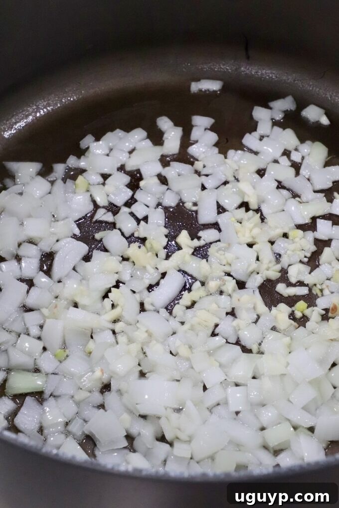 diced onions and minced garlic cooking in large pan