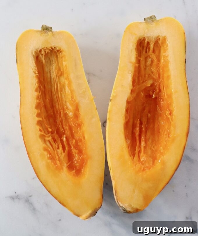delicata squash cut in half with the seeds removed