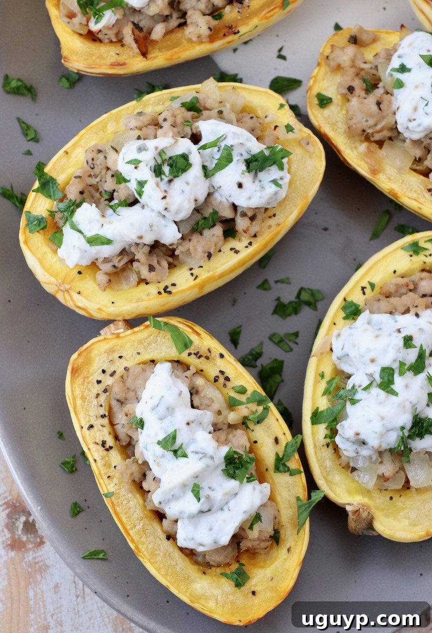 A perfectly cooked stuffed delicata squash half, generously filled with savory chicken sausage and creamy herb ricotta, beautifully presented on a plate, garnished with fresh herbs, ready to be served.