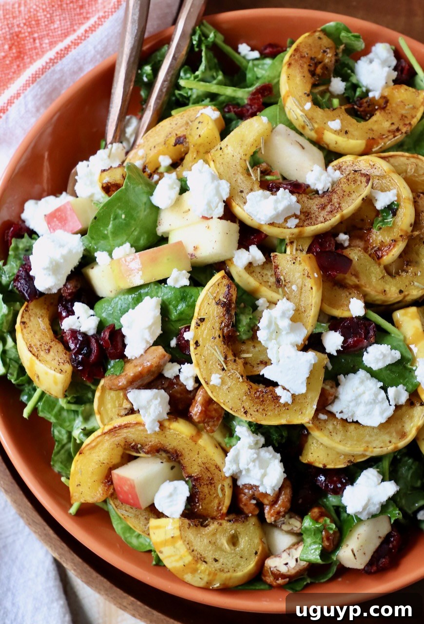 Delicata Squash Salad with roasted delicata squash, crumbled goat cheese, and vibrant greens in a bowl