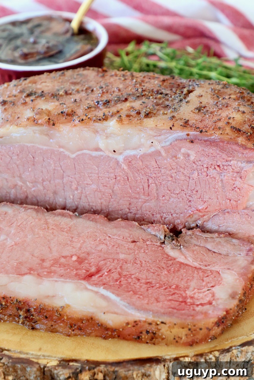 Smoked New York Strip Roast sliced on a wooden board, ready to serve.