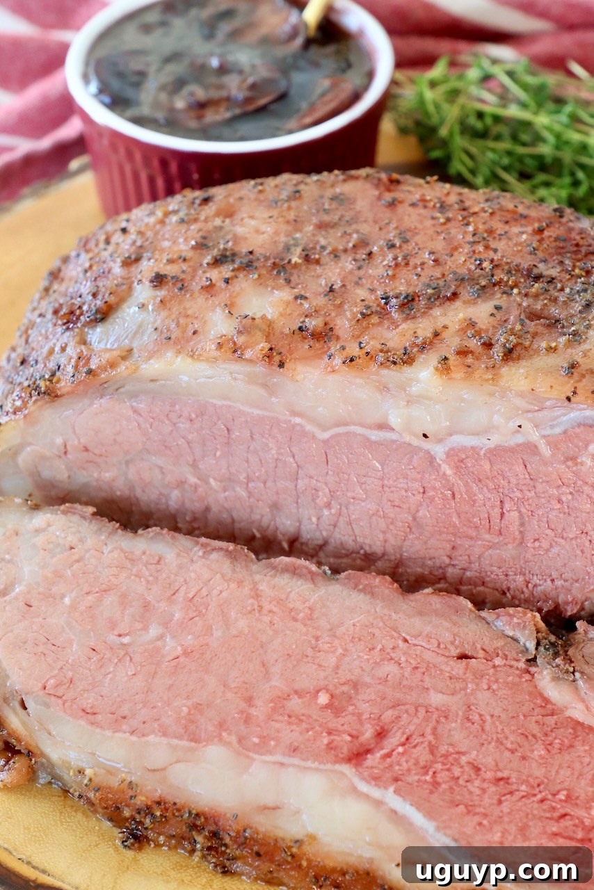 Smoked strip roast, perfectly sliced and arranged on a wooden serving tray.