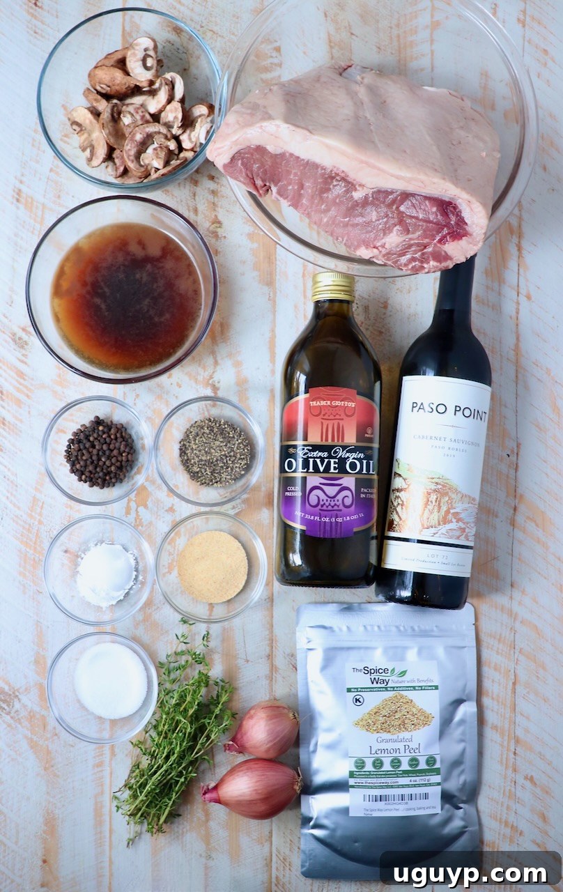 Ingredients laid out for a Smoked New York Strip Roast on a white wooden board.