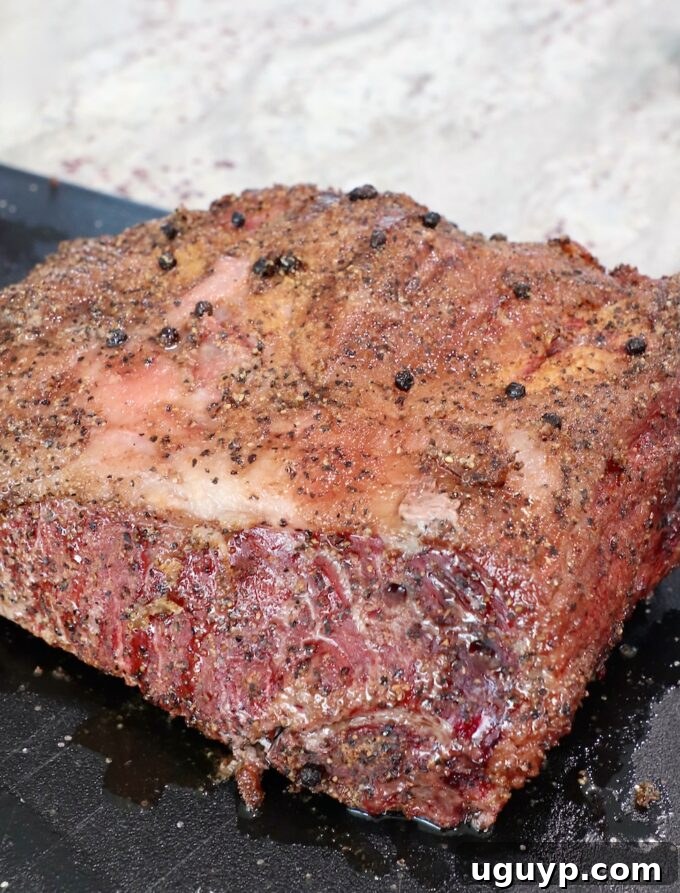 Smoked and seared New York Strip Roast on a cutting board.
