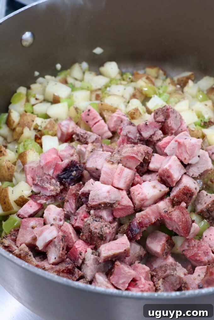 Cooked, diced steak added to the potato and vegetable hash in the Dutch oven.