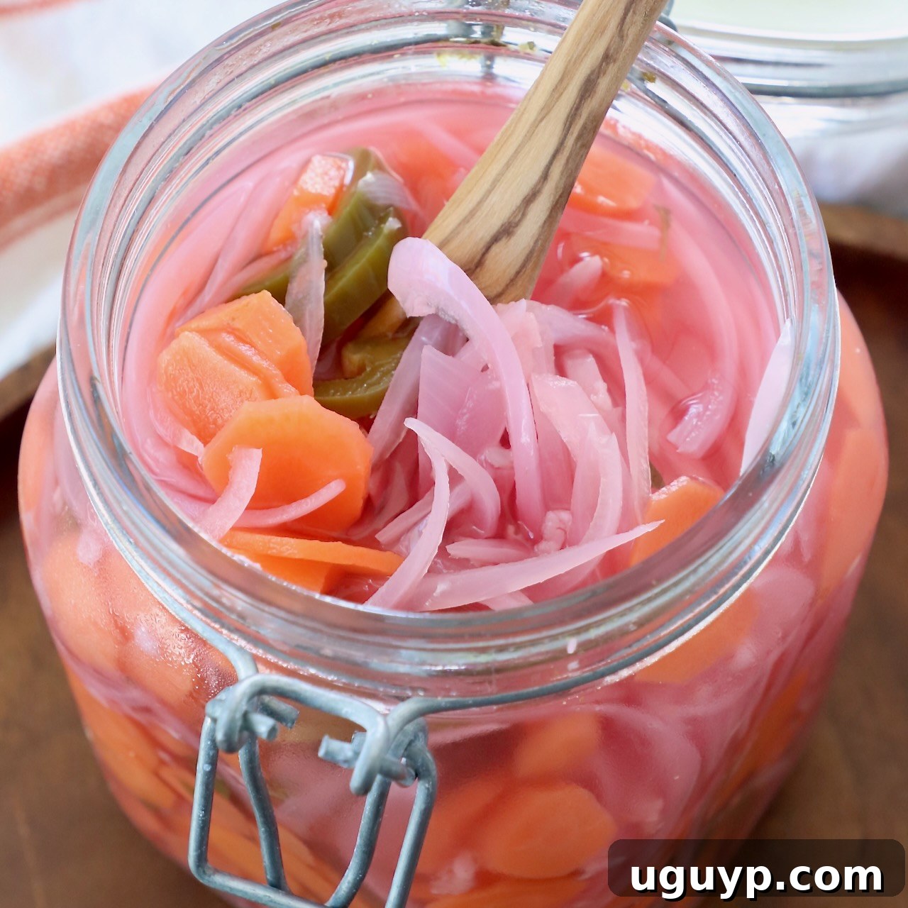 pickled onions, carrots and jalapenos in large glass mason jar