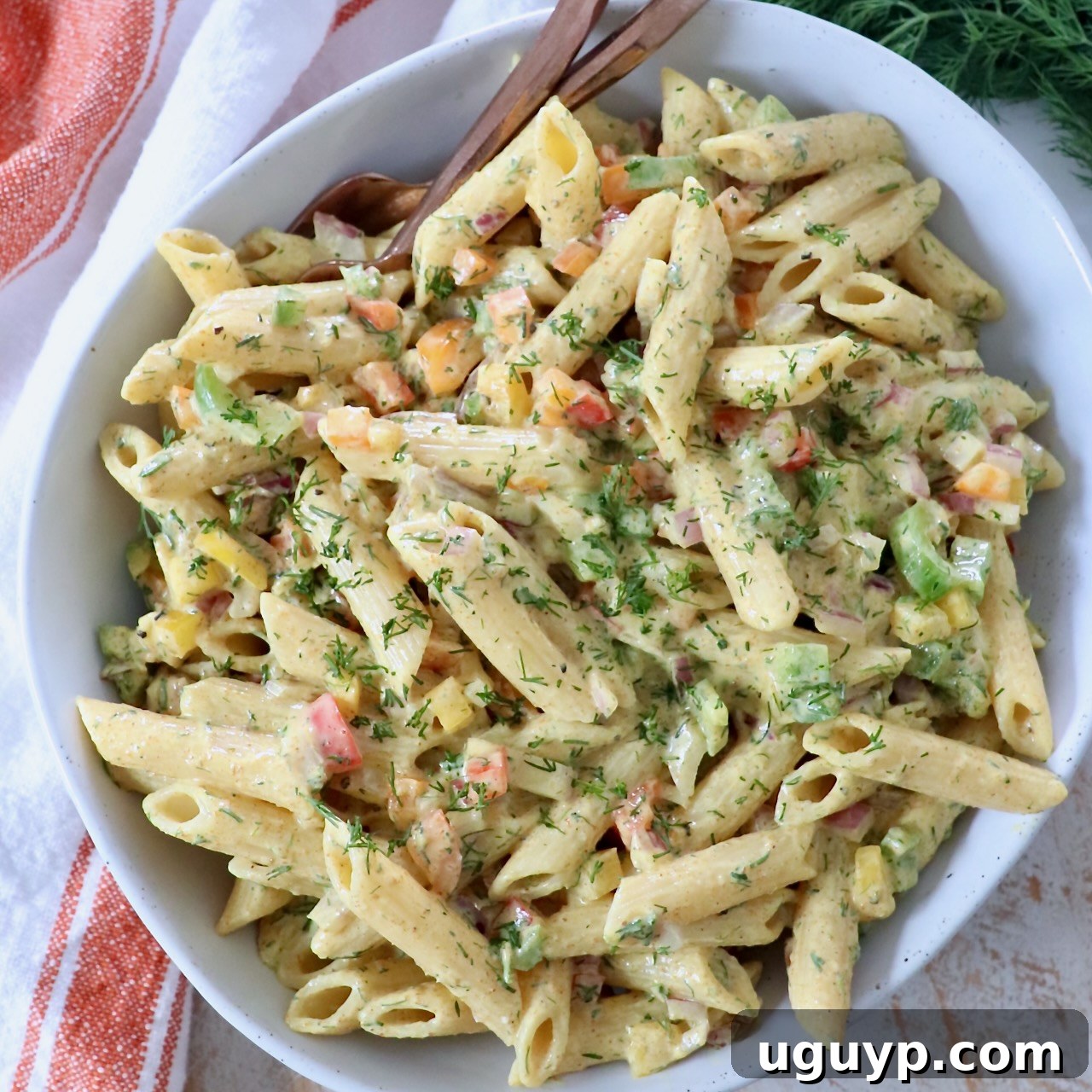 prepared pasta salad in bowl with forks