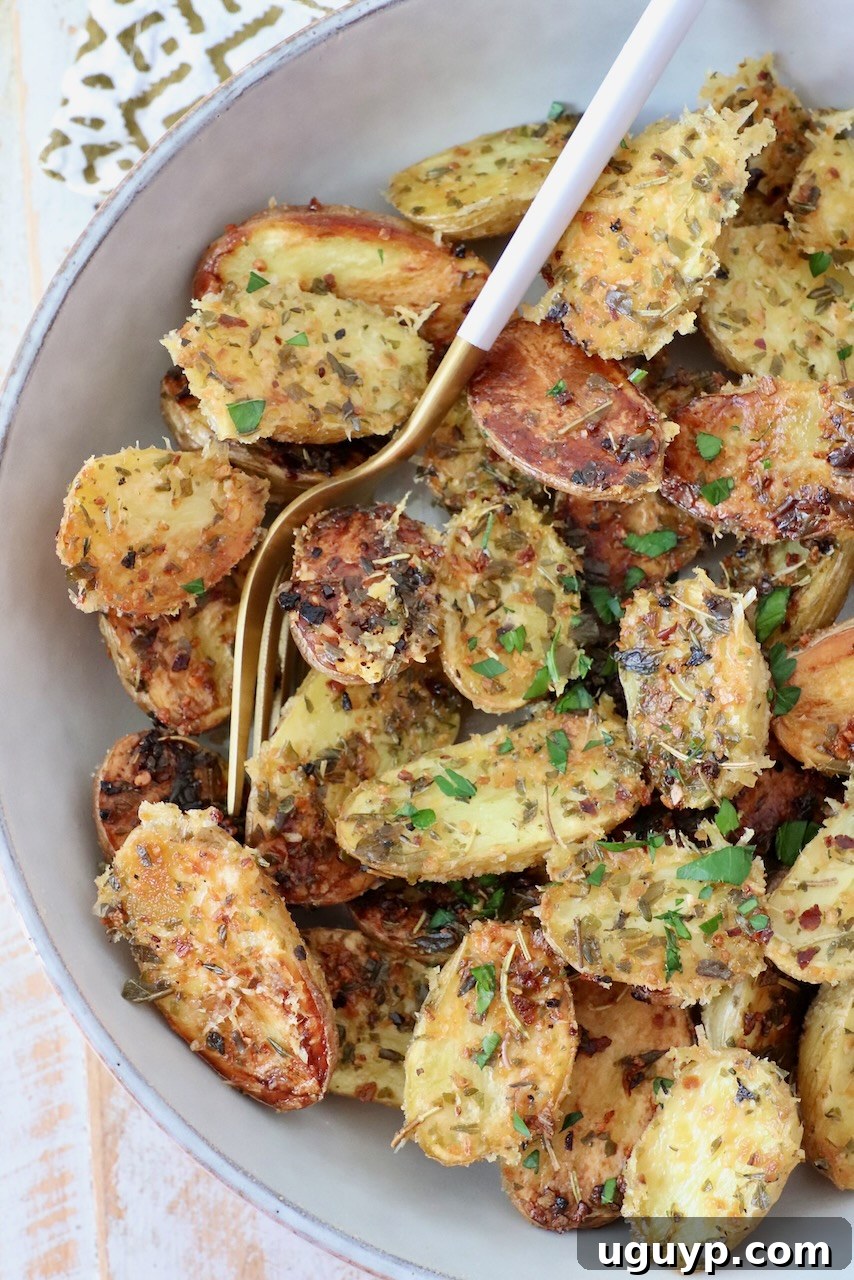 Crispy oven roasted baby potatoes served in a bowl with a fork, ready to eat.