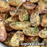 Crispy oven roasted baby potatoes in a bowl with a fork.