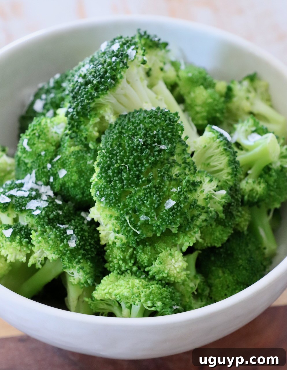 A bowl of freshly steamed broccoli, vibrant green and perfectly tender.