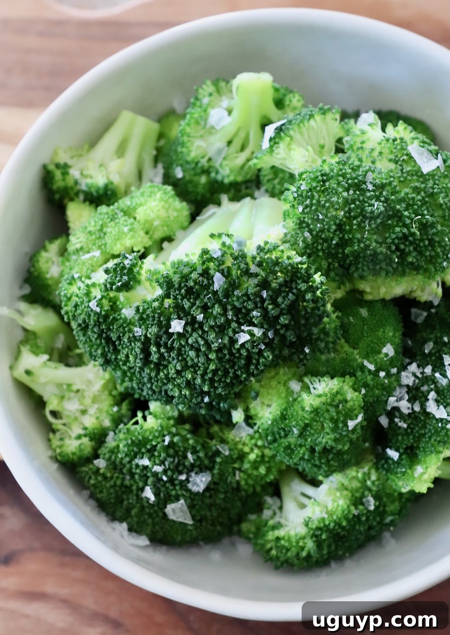 Close-up of vibrant green steamed broccoli in a bowl, perfectly cooked.