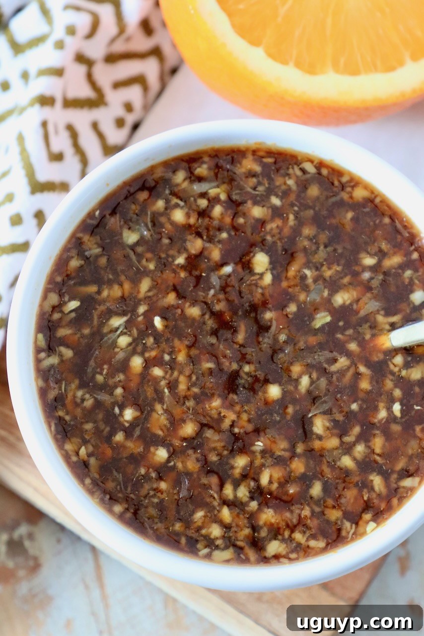 A glistening bowl of homemade Chinese orange sauce, ready for serving.