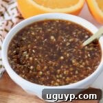 Small bowl of orange sauce with a spoon.