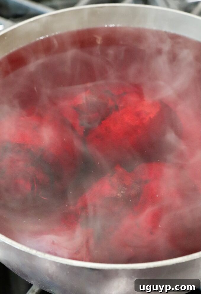 beets boiling in water in a pot on the stove