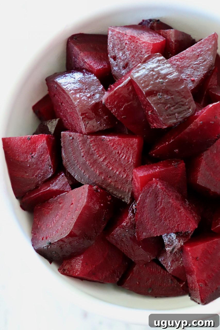 cooked diced beets in a white bowl
