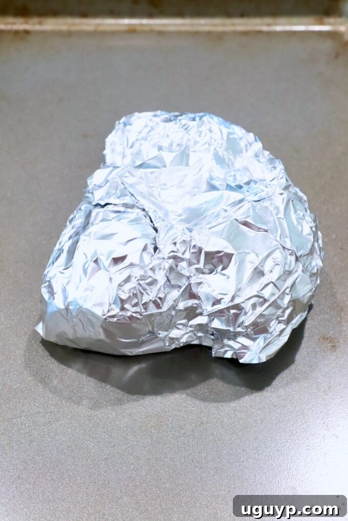 beets wrapped up in foil on baking sheet