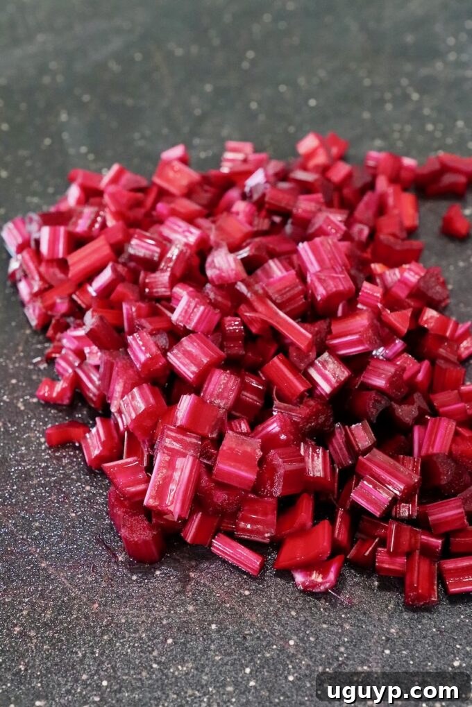 Finely minced beet stems gathered on a cutting board, prepared for cooking.