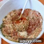 A close-up shot of homemade Southwest seasoning in a bowl with a spoon.