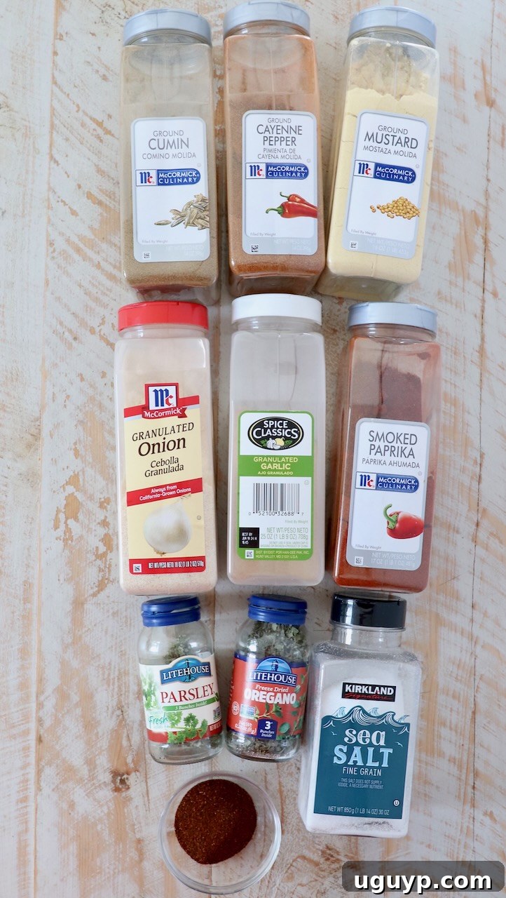 Individual ingredients for homemade Southwest seasoning arranged artfully on a white wooden board.