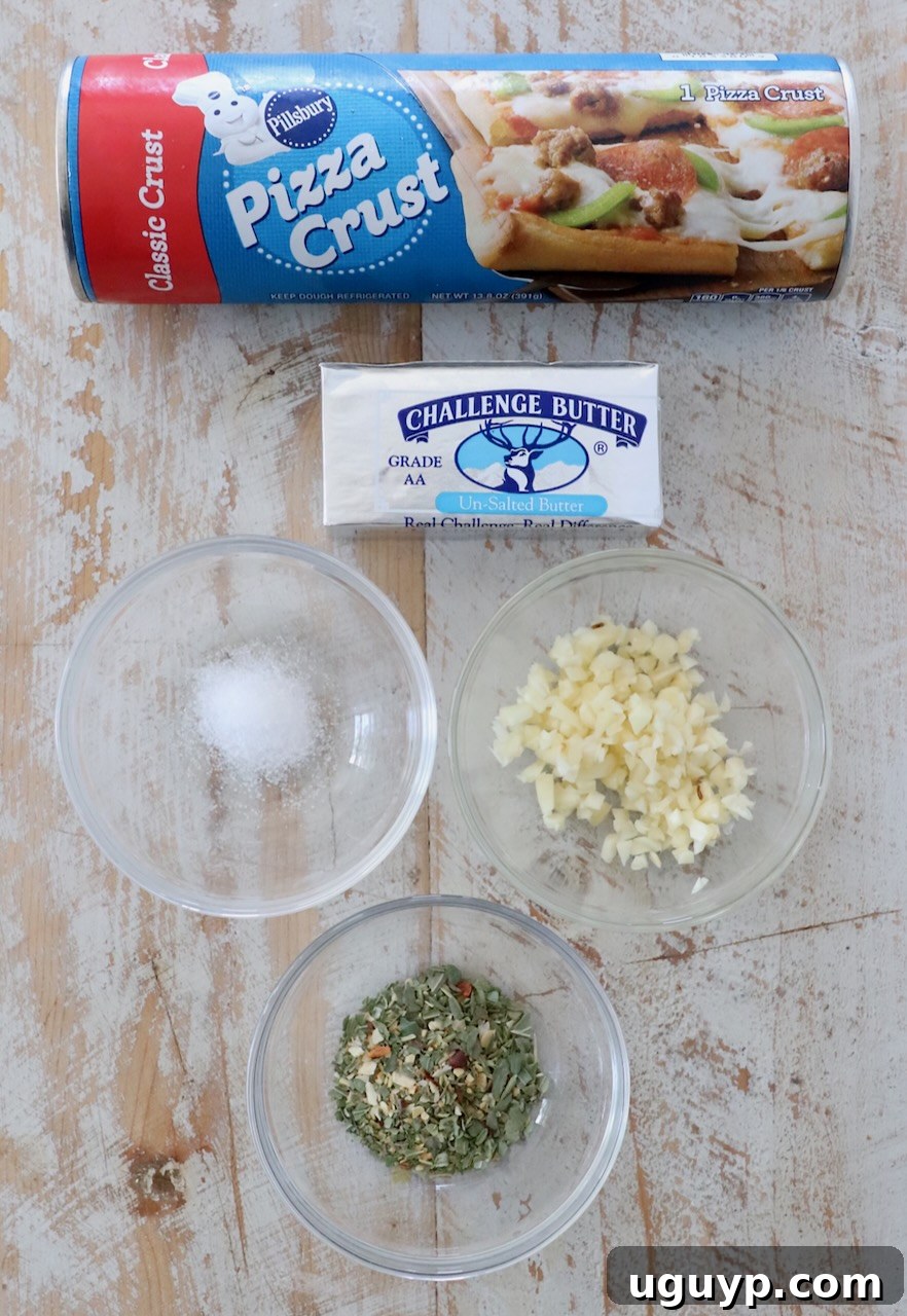 Ingredients for homemade garlic knots laid out on a white wooden board, including pizza dough, butter, and fresh garlic.