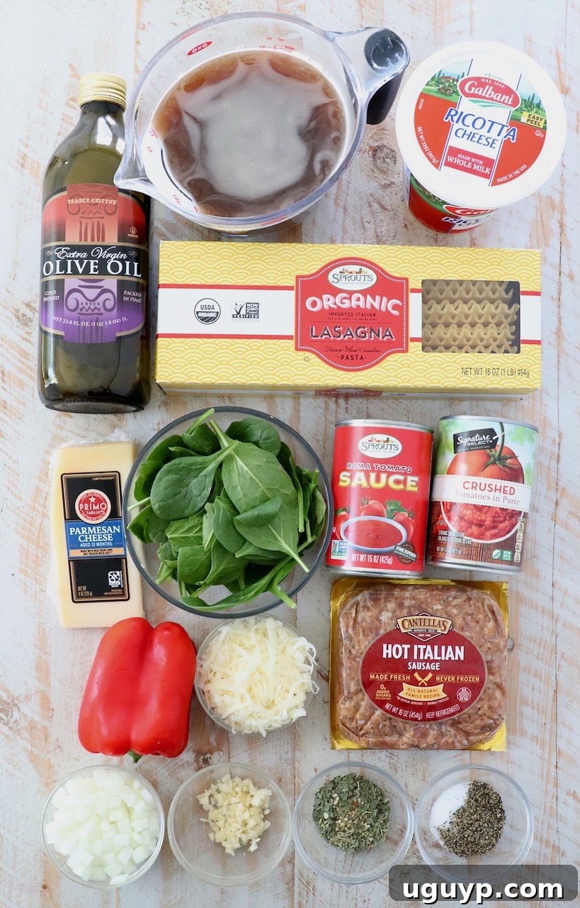 Ingredients for lasagna soup laid out on a white wooden board, including fresh vegetables, spices, and sauces.