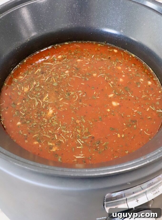 Italian seasoned tomato sauce poured into a slow cooker.
