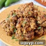 Mexican Chorizo Bisquick Sausage Balls on yellow plate with jalapenos and shredded cheddar cheese