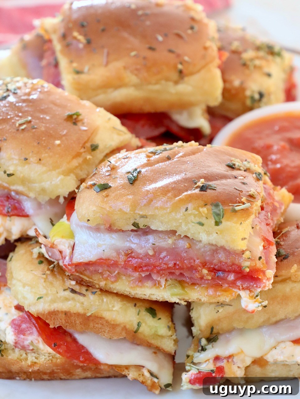Hot Italian Sliders stacked neatly on a plate, ready to be served