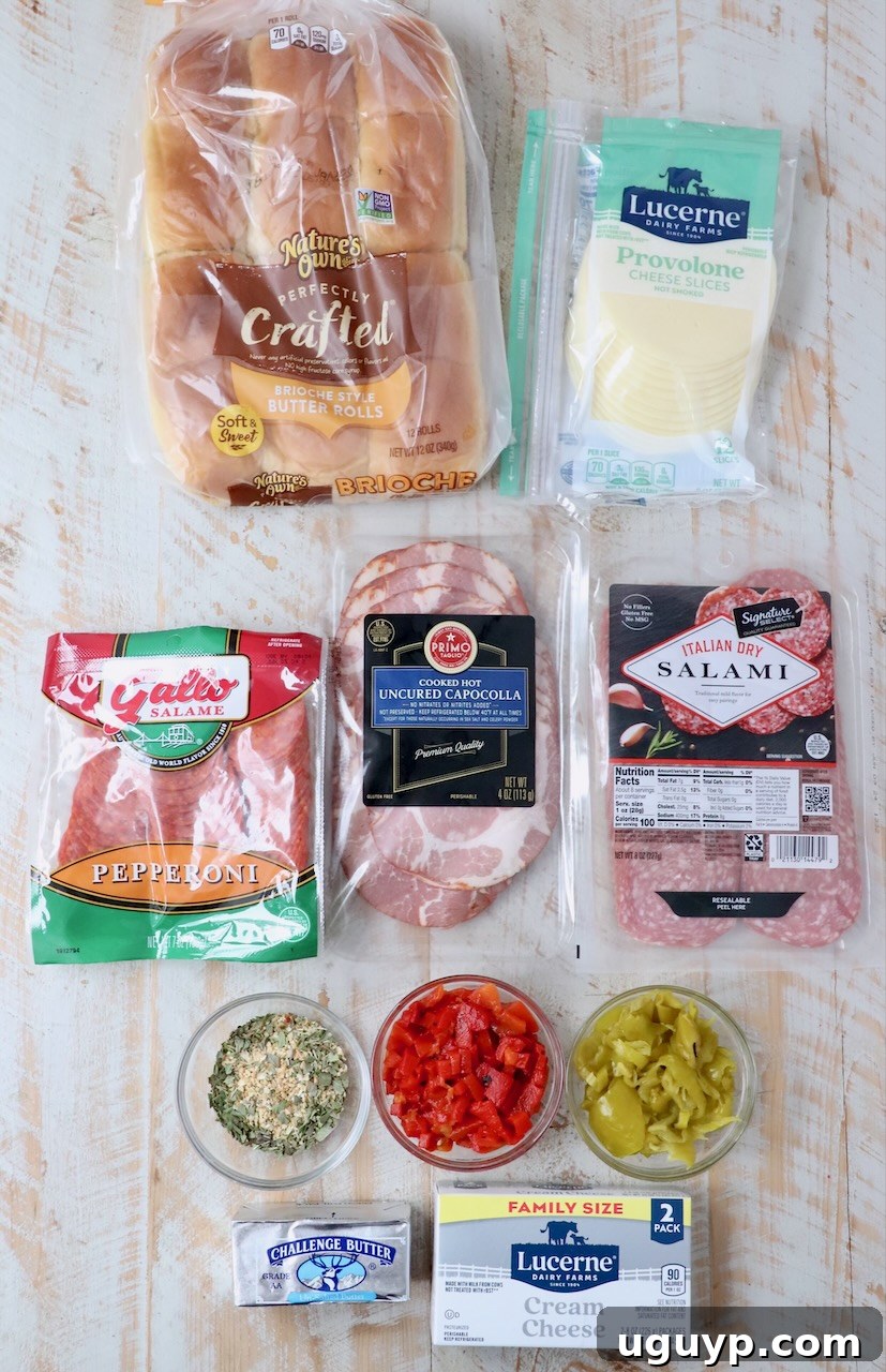 Ingredients for Hot Italian Sliders laid out on a white wooden board