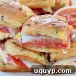 Hot Italian Sliders stacked up on plate