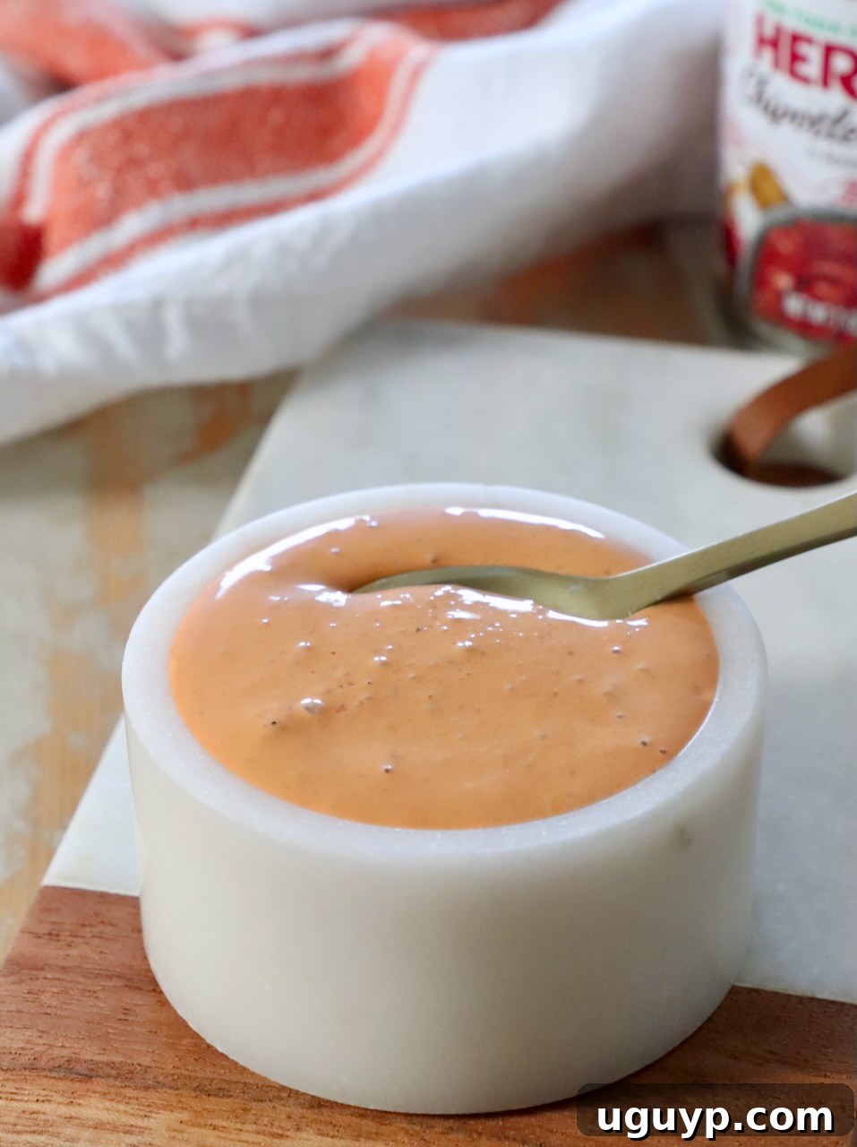chipotle sauce in bowl with spoon, garnished with cilantro
