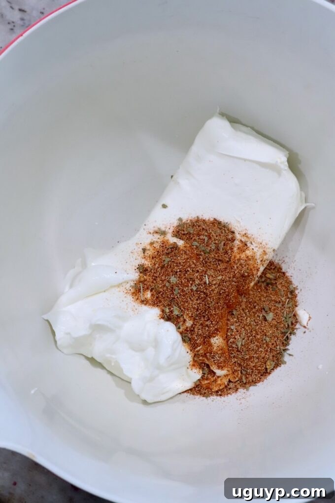 cream cheese, sour cream and spices in large bowl