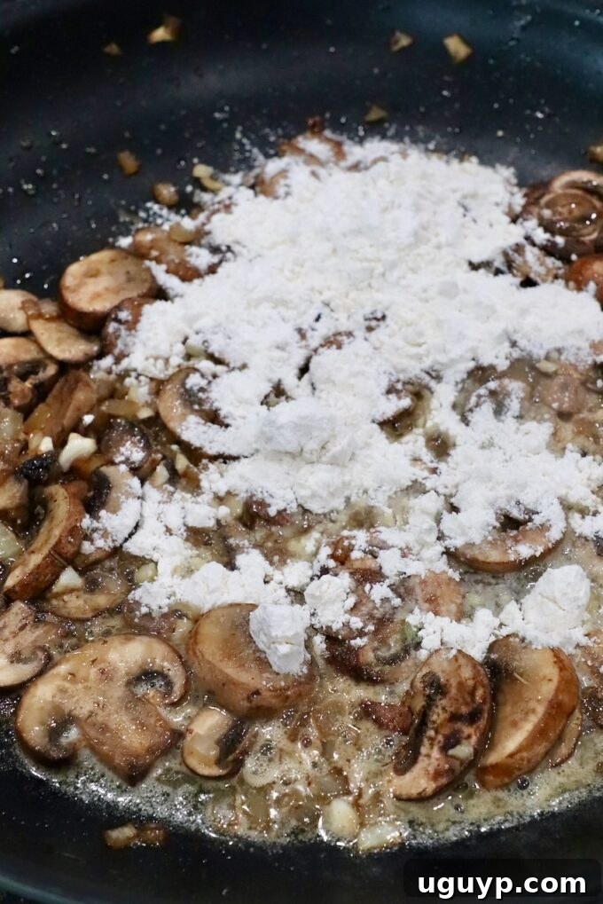 mushrooms covered in flour in skillet