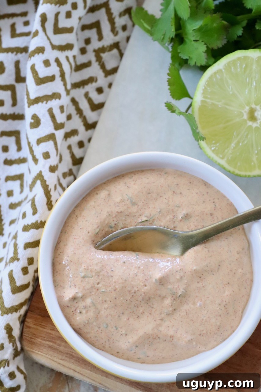 Creamy Southwest Salad Dressing in a small bowl with a spoon, ready to serve.
