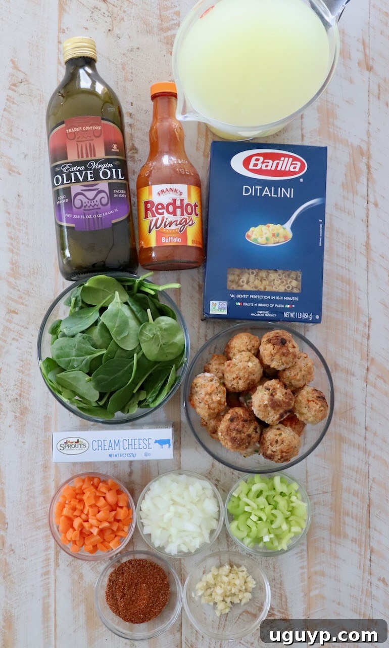 Fresh ingredients for Buffalo Chicken Meatball Soup arranged on a white wooden board.