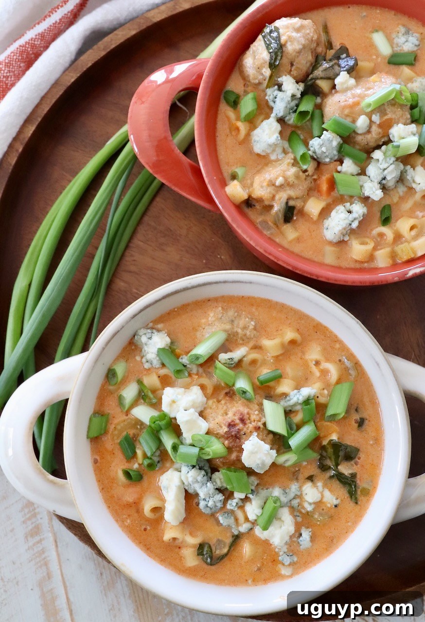 Buffalo Chicken Soup in bowls garnished with fresh green onions.