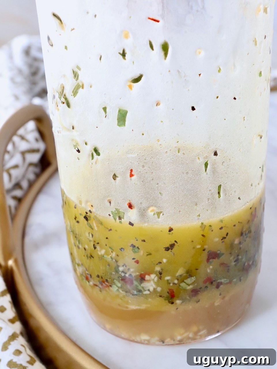 Freshly made Italian dressing in a mason jar, ready to be used on salads.