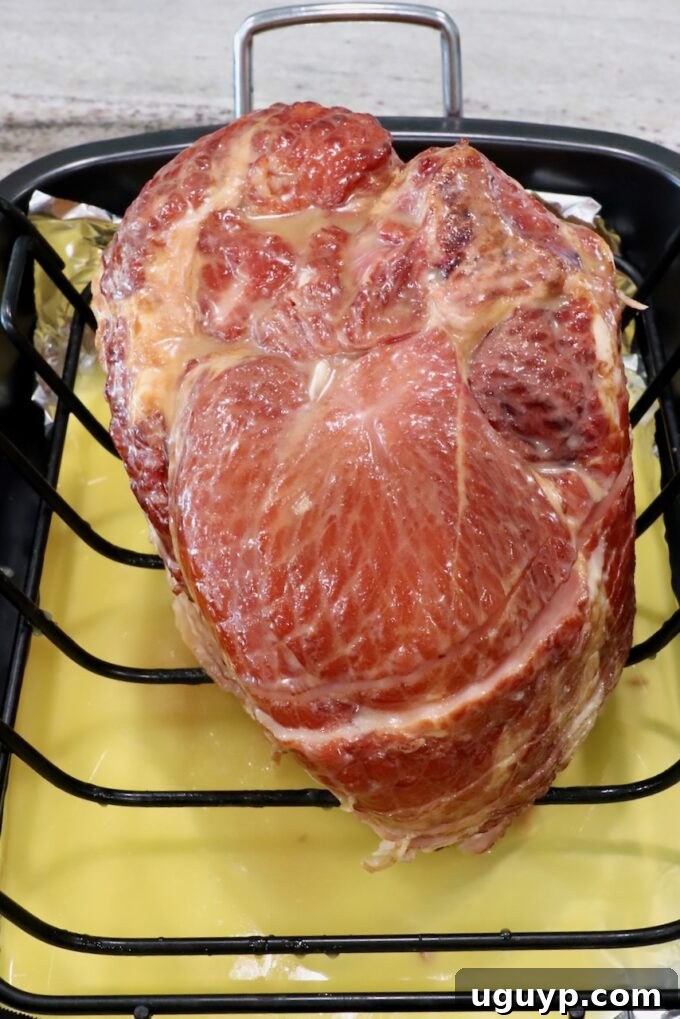 honey glazed ham in roasting pan, ready for the oven