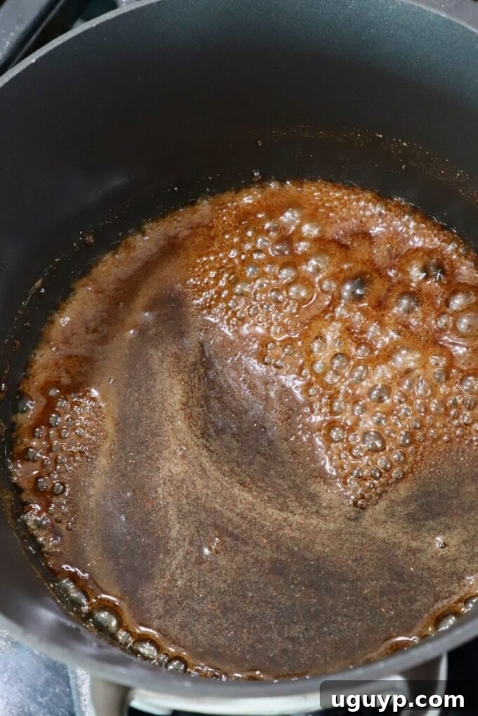 brown sugar glaze simmering in a saucepan on the stove