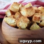 Golden homemade croutons in a wooden bowl.