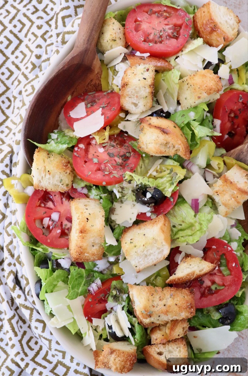 salad in large serving bowl with serving spoon