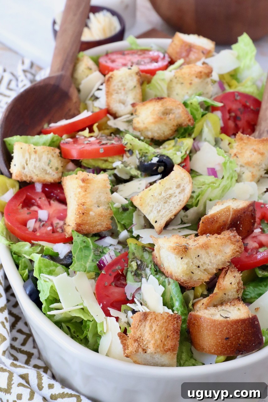 Italian salad in bowl with serving spoon